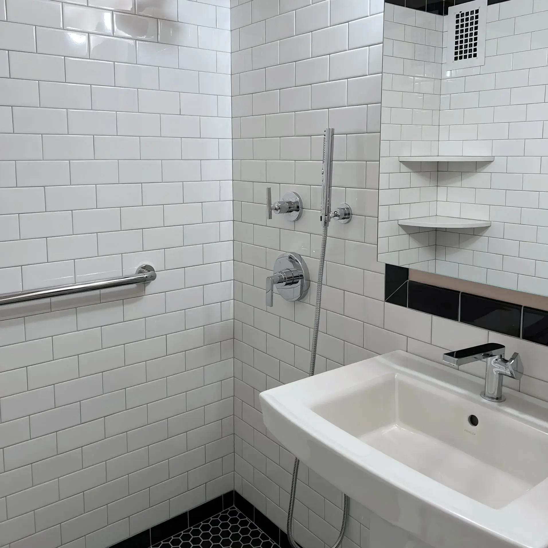 ADA-accessible bathroom with grab bars and walk-in shower