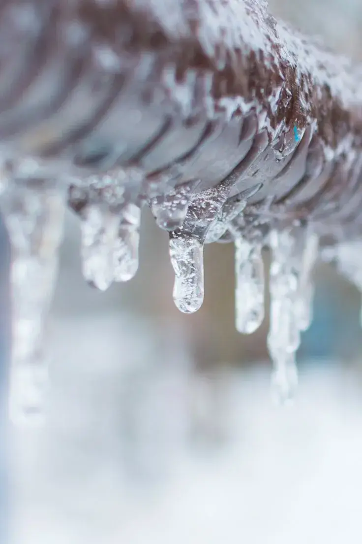 Frozen pipe with icicles forming