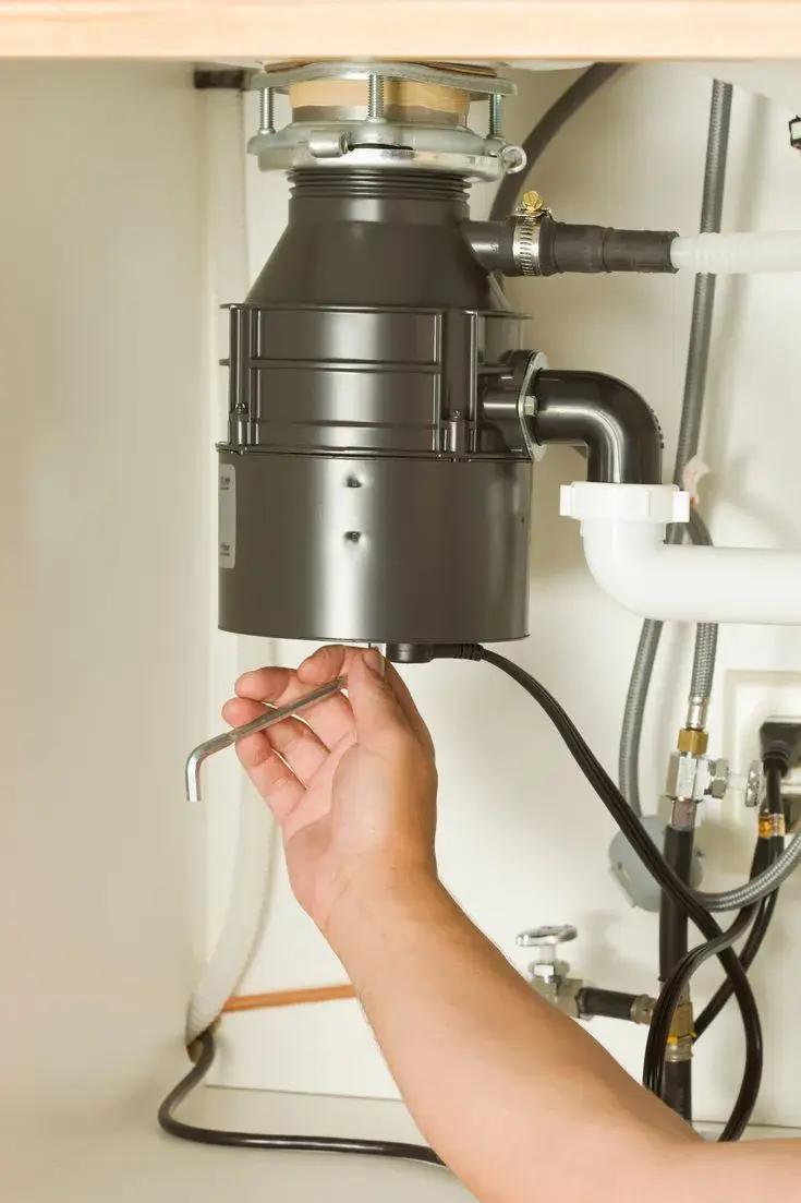 Garbage disposal repair under a kitchen sink