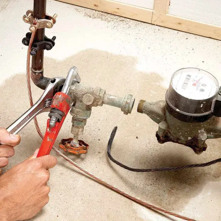 Plumber working on a water meter valve