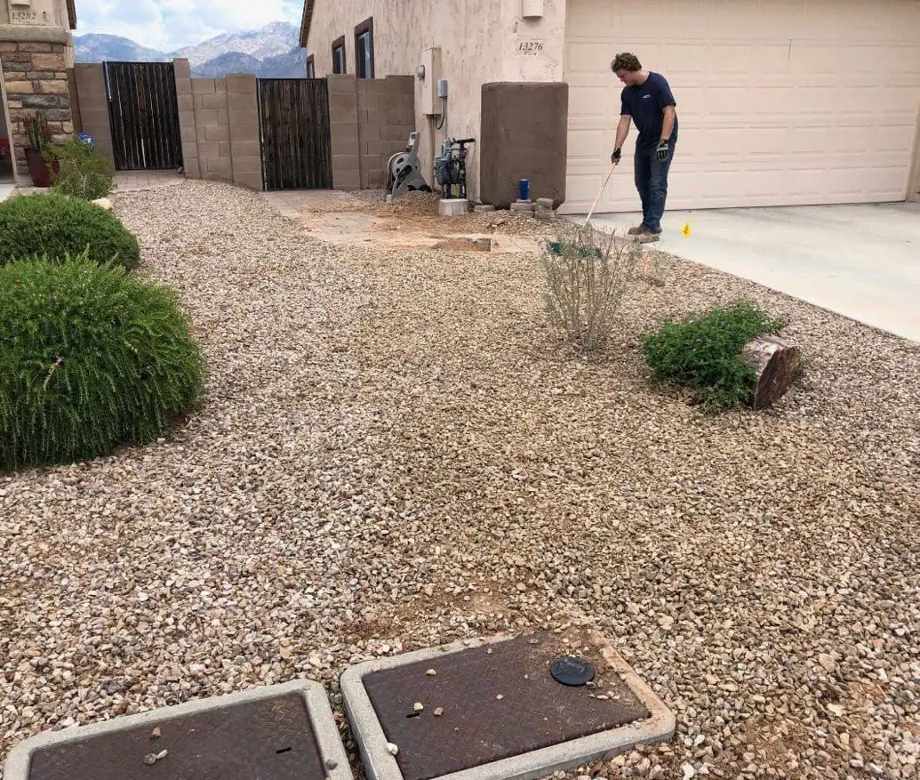 Technician working in the front yard of an East Valley home