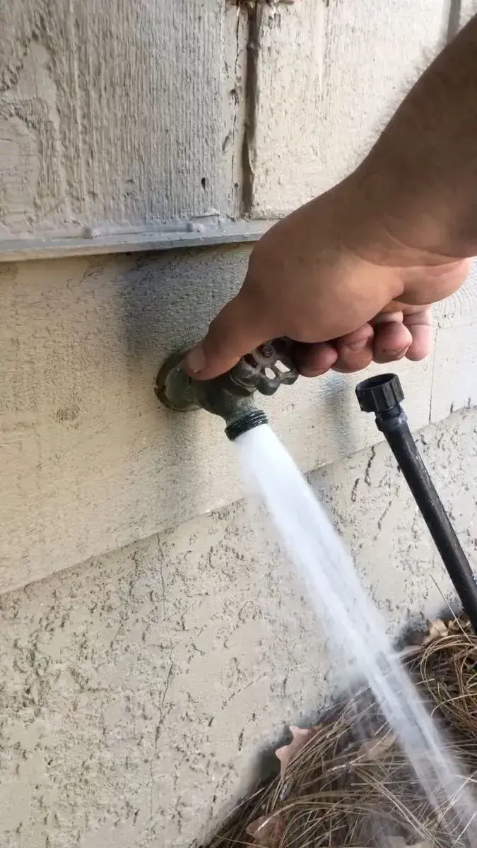 Water flowing from an outdoor hose spigot