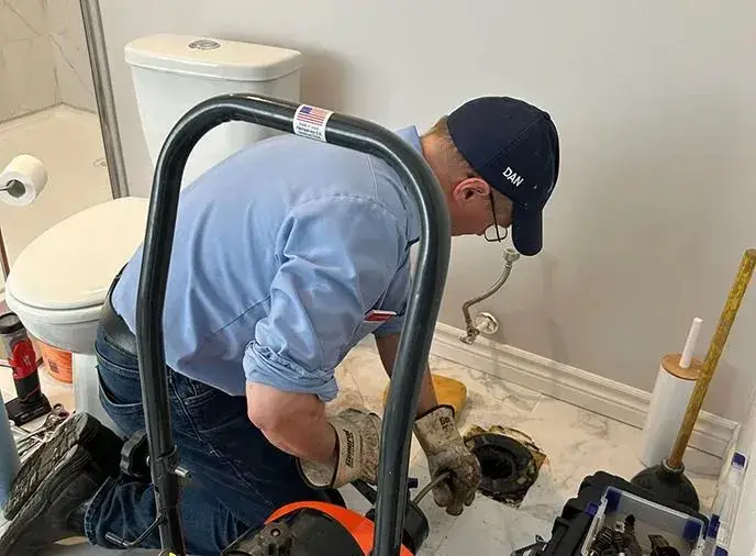 Master plumber inspecting a bathroom plumbing issue
