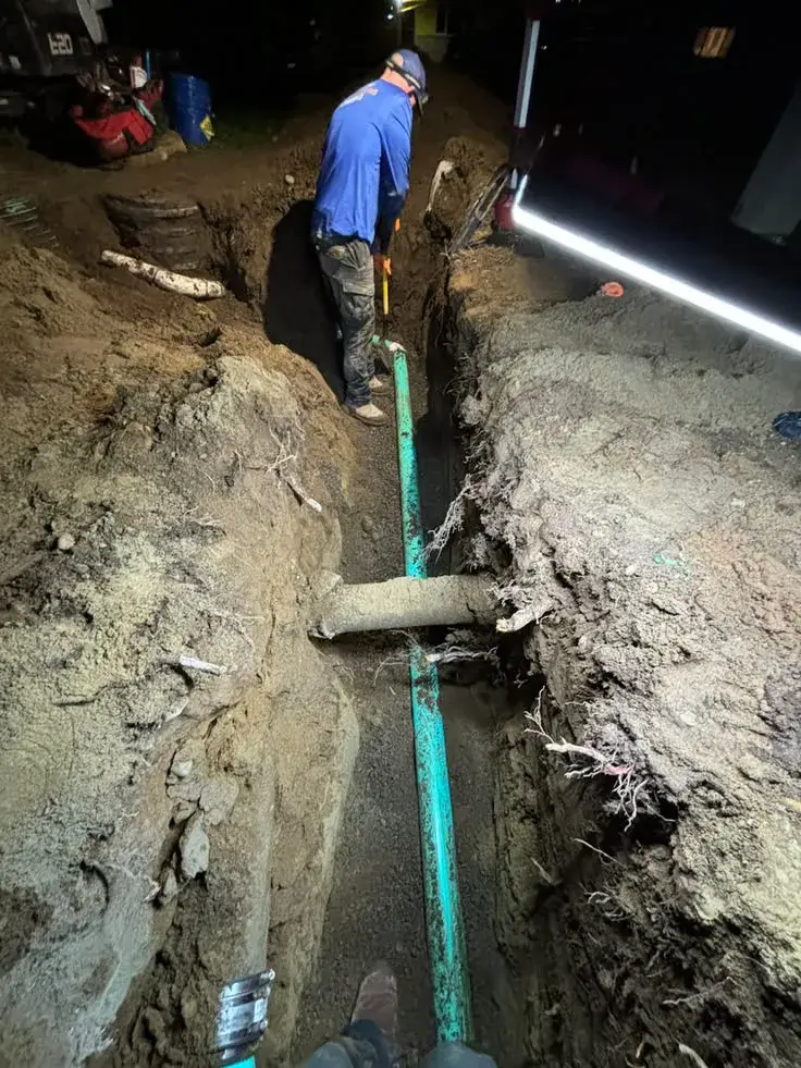 Open trench exposing a commercial sewer line during repair work