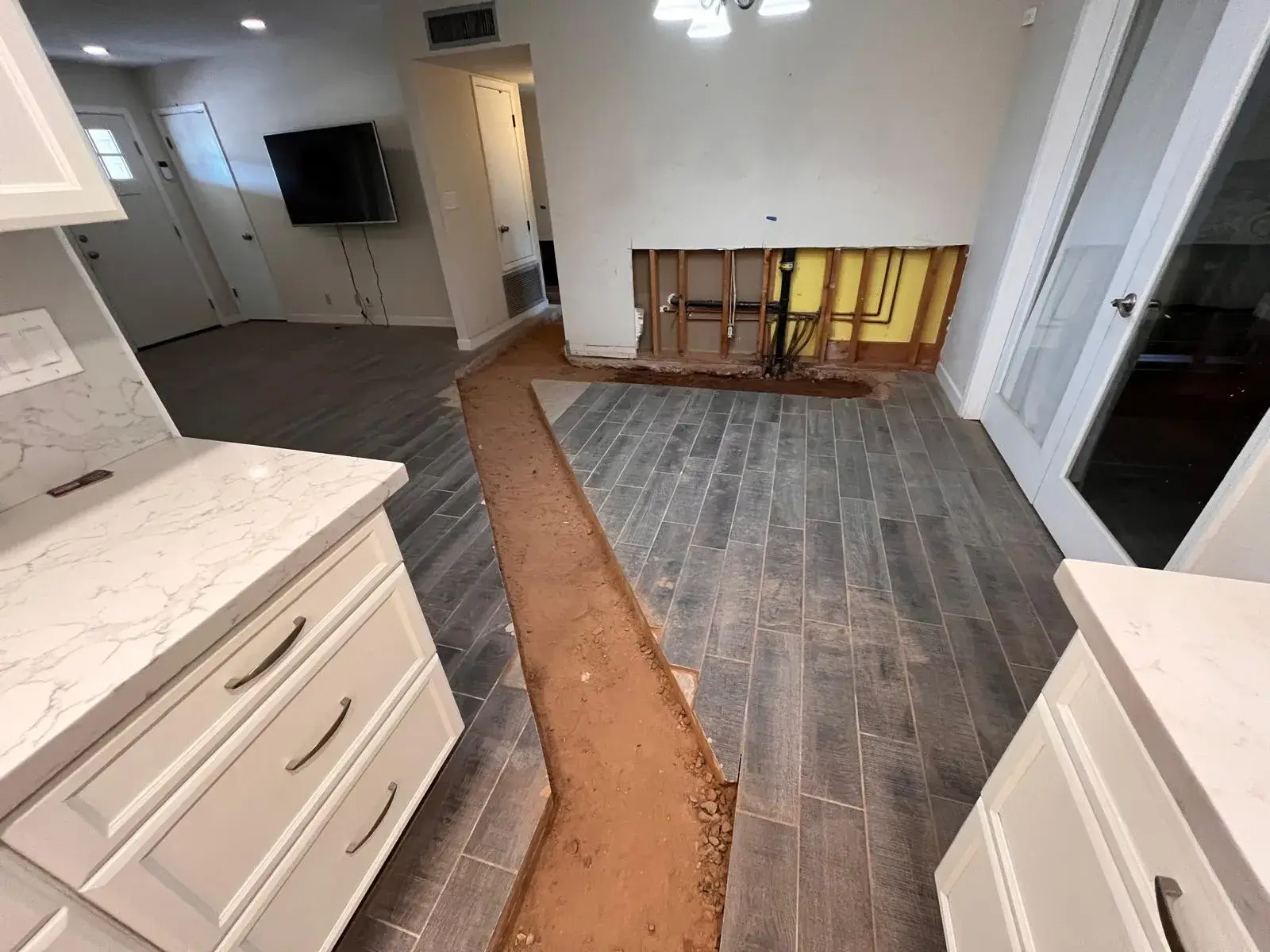 Excavated trench for pipe repair